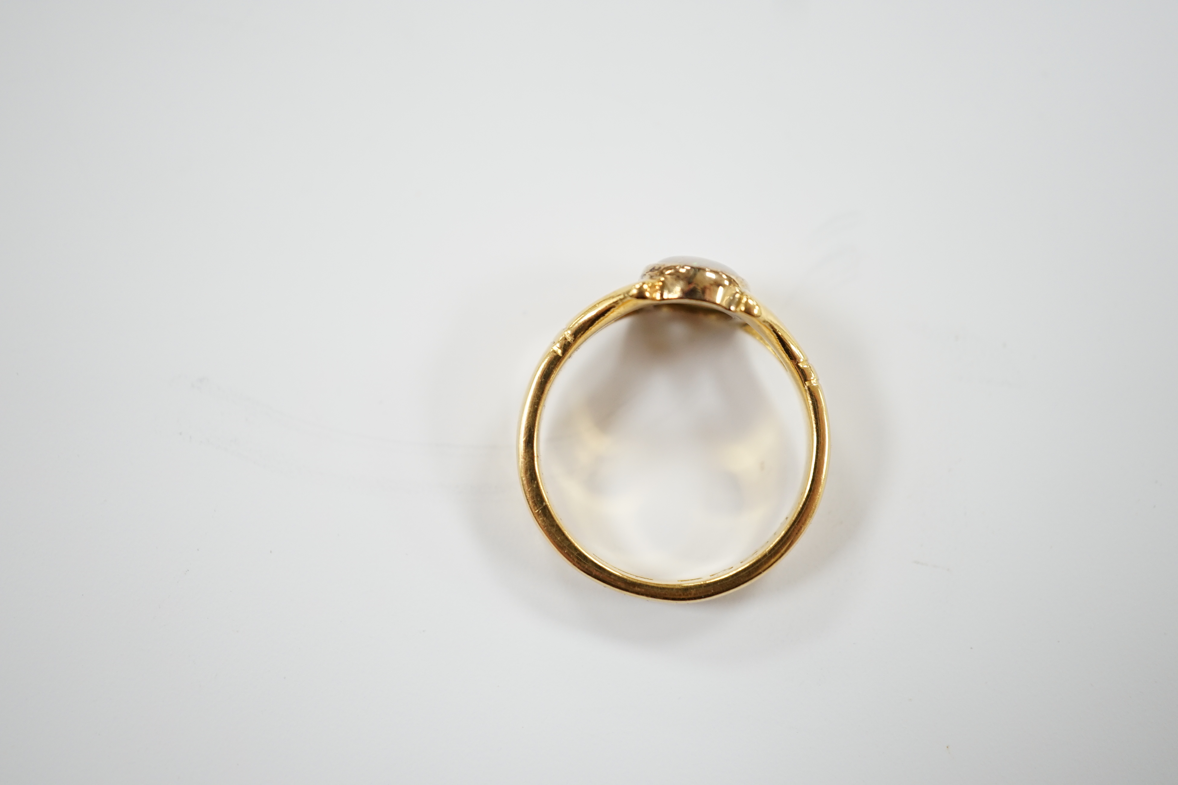 A George V 22ct gold and single stone cabochon white opal set ring, size P/Q, gross weight 6.5 grams.